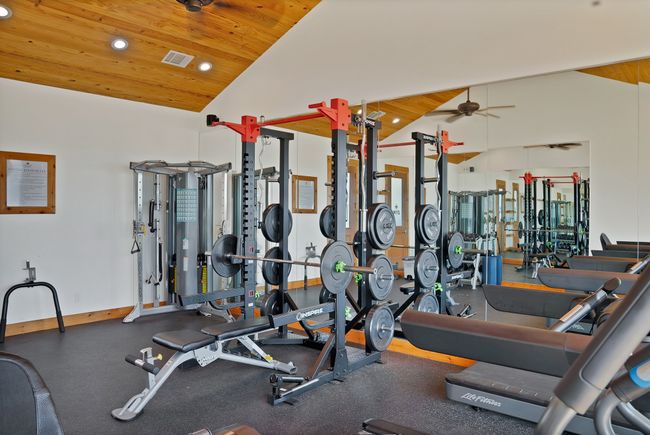 Exercise room with wood ceiling, a ceiling fan, recessed lighting, and high vaulted ceiling | Image 16