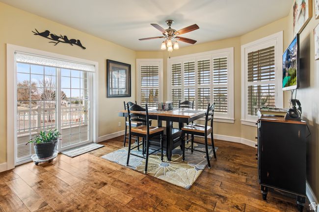 Dining space featuring dark hardwood / wood-style floors and ceiling fan | Image 35