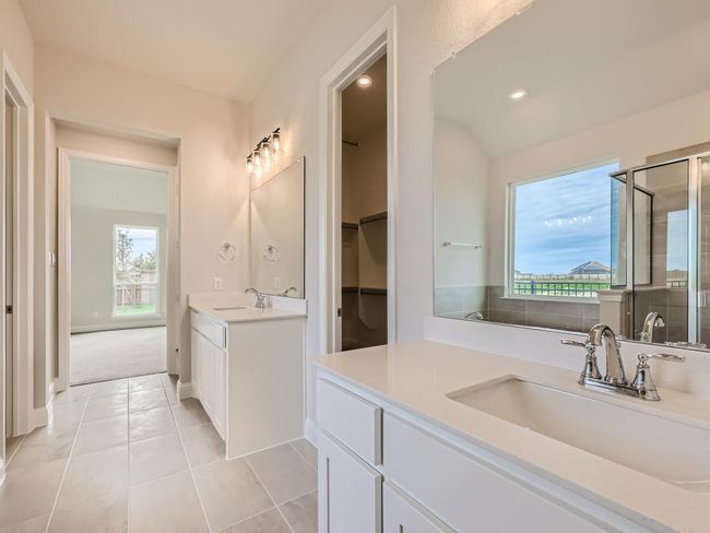 Full bath with a shower stall, tile patterned flooring, a sink, and two vanities | Image 16