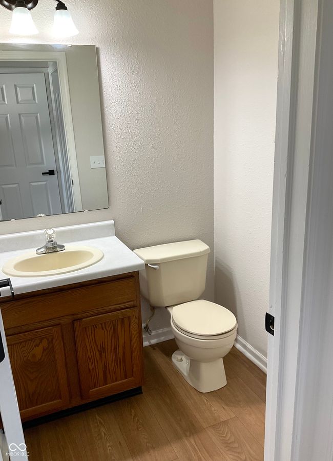 Main level half bath with ne paint and flooring. | Image 14