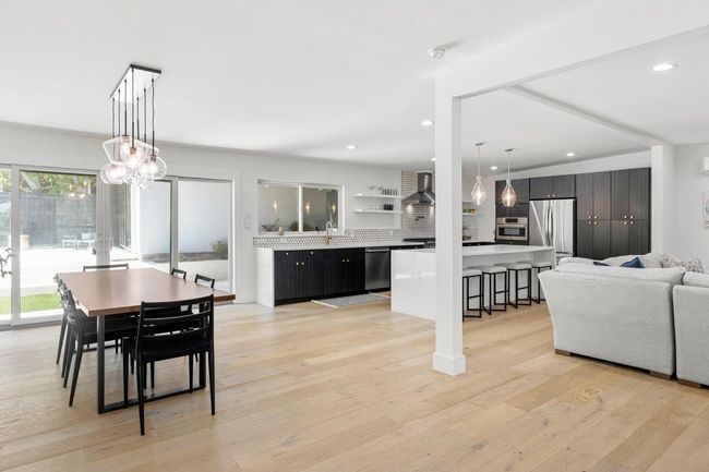 Dining room featuring a chandelier, light wood-style floors, and recessed lighting | Image 8