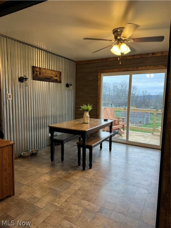 Dining room with tile floors and ceiling fan | Image 10