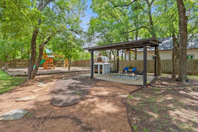 Fenced backyard with a patio area and a playground | Image 35