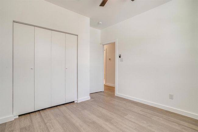 Unfurnished bedroom with light wood-style flooring, a closet, ceiling fan, and baseboards | Image 32