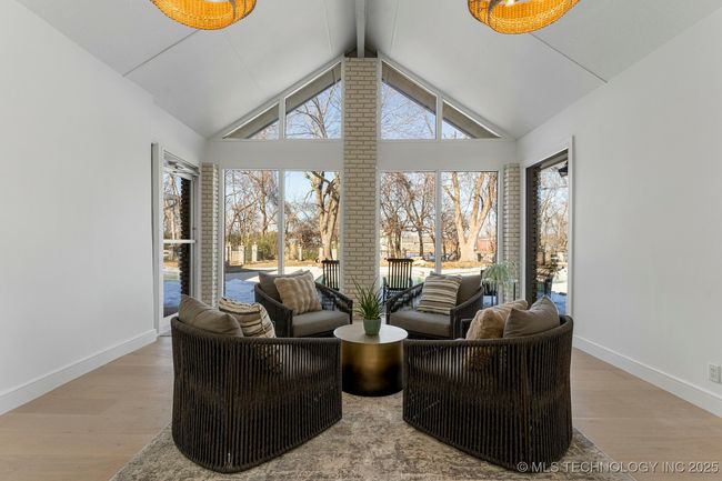 Sun room with vaulted ceilings and a bathroom that leads to the pool | Image 30