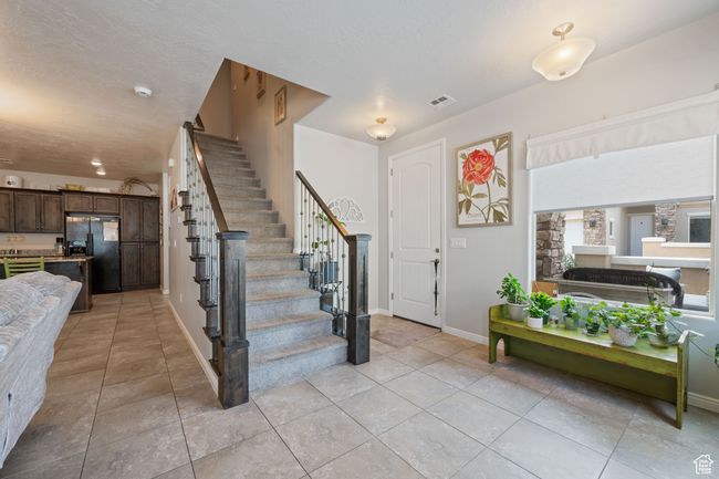 Entryway featuring stairway and light tile patterned flooring | Image 6