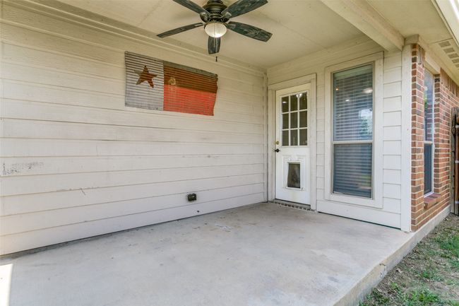 Enjoy outdoor living on the covered patio with ceiling fan. | Image 31
