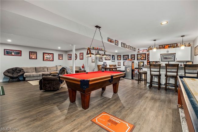 Rec room featuring hardwood / wood-style flooring, bar area, and billiards | Image 37