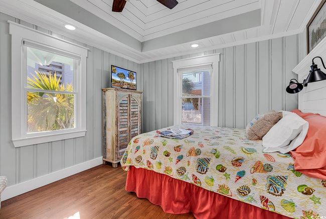 Bedroom with multiple windows, wood-type flooring, crown molding, and ceiling fan | Image 18