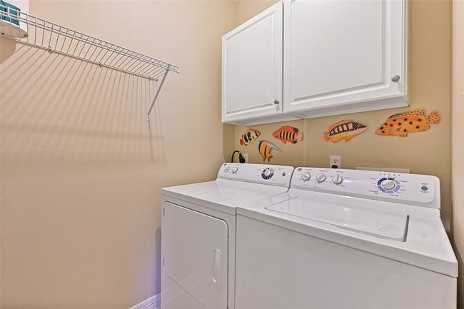 Efficient laundry area with ample storage. | Image 18