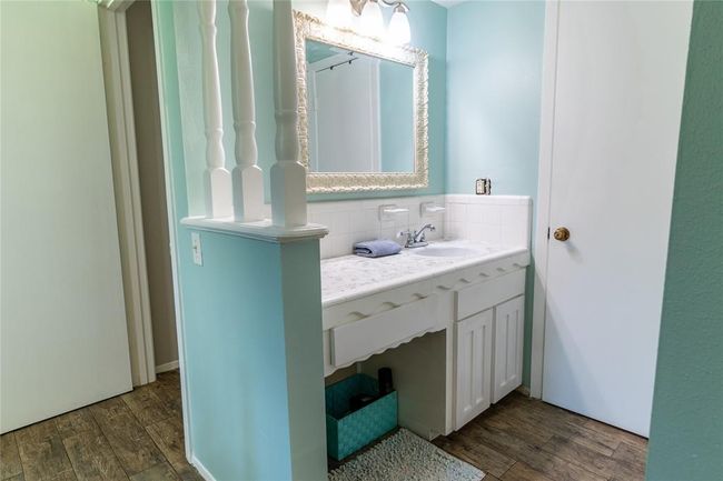 Separate vanity and sink in bedroom adjacent to upstairs bath. Door to the right is how upstairs bath is accessed. | Image 20