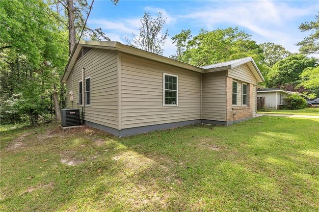 View of home's exterior with a yard and cooling unit | Image 37