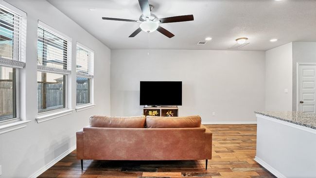 Living area with visible vents, baseboards, recessed lighting, light wood-style floors, and a ceiling fan | Image 11