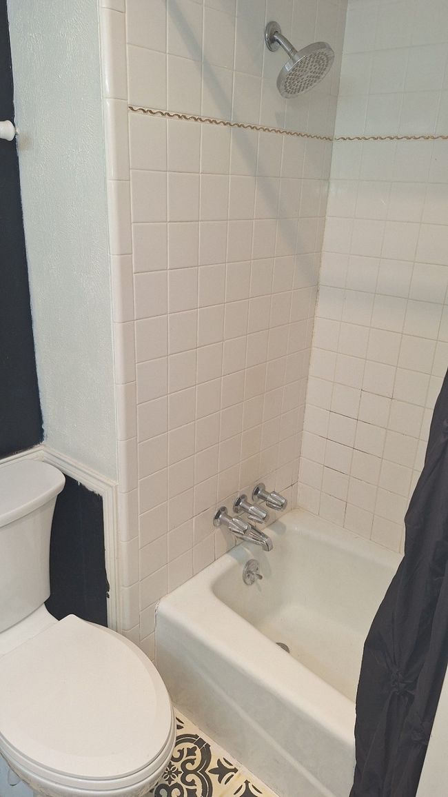 Full bathroom with toilet and shower / bath combination with curtain | Image 23