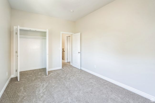 Unfurnished bedroom featuring carpet and a closet | Image 39