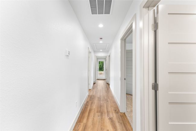 Corridor featuring light wood-type flooring, recessed lighting, baseboards, and attic access | Image 27