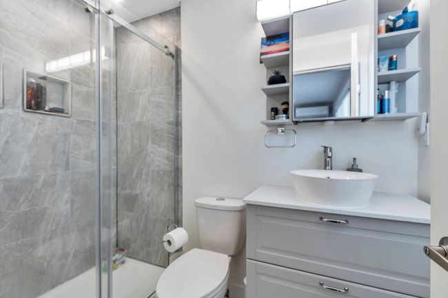 Full bathroom with vanity, toilet, and tiled shower | Image 18