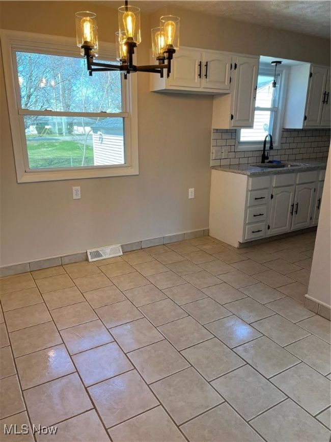 Dining Area with new chandelier. | Image 11