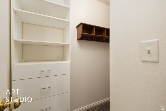 Walk in closet featuring carpet floors | Image 13