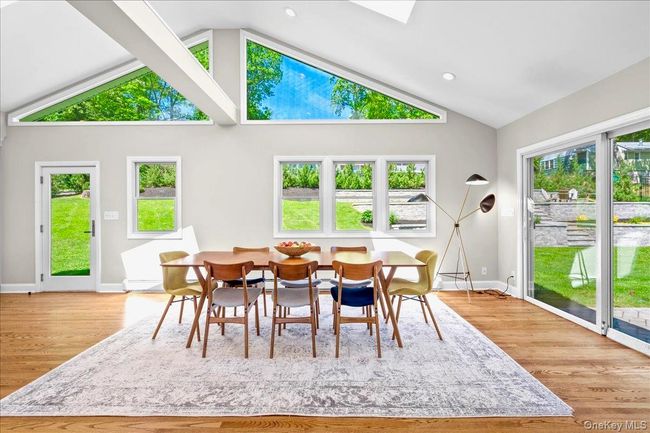 Dining area with lofted ceiling, wood finished floors, baseboards, healthy amount of natural light, and recessed lighting | Image 16
