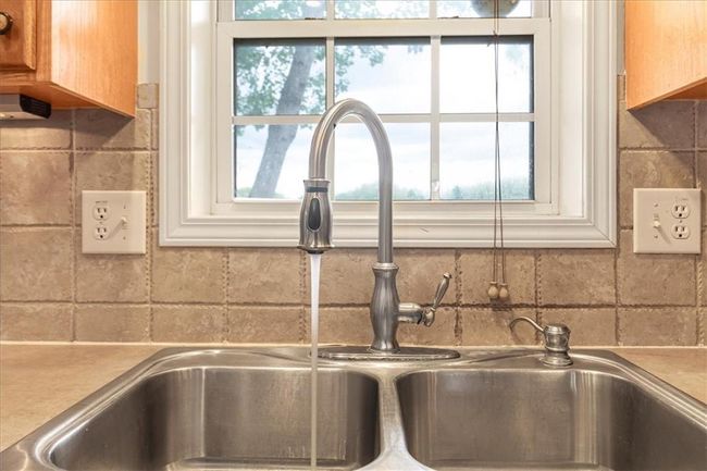 Details featuring a sink and tasteful backsplash | Image 18