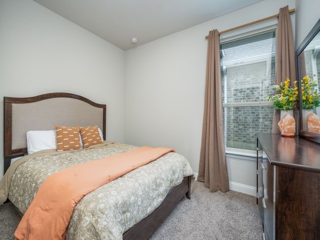 Third guest bedroom is thoughtfully designed for comfort and functionality. | Image 13