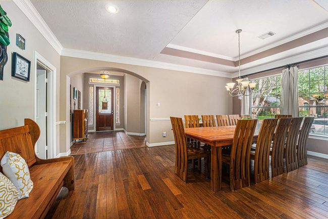 Elegant formal dining room with tons of natural light. | Image 6