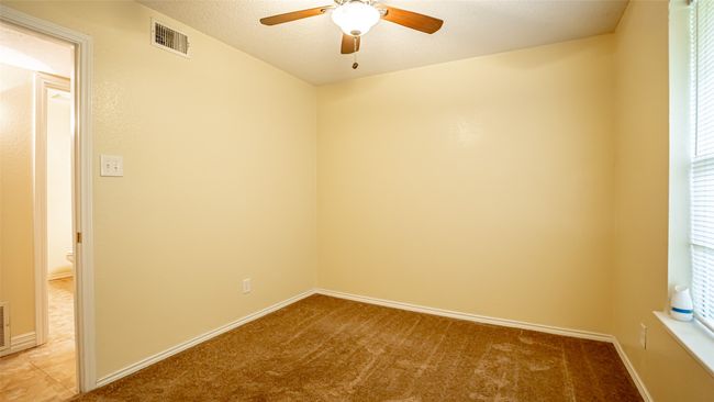 Empty room with ceiling fan, light colored carpet, and baseboards | Image 17