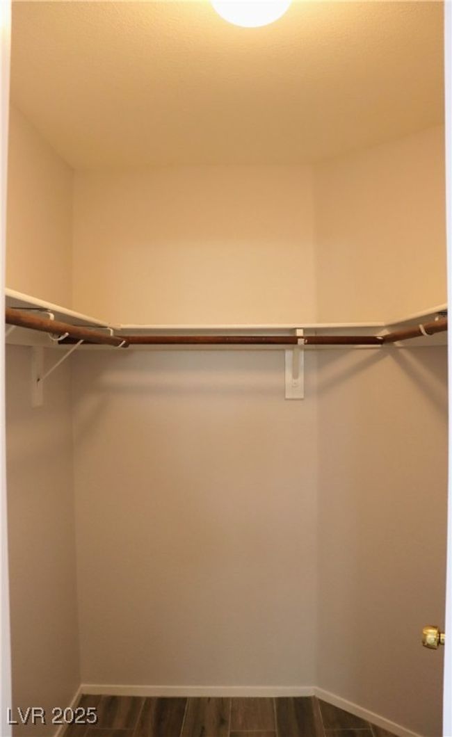 Corridor featuring attic access, wood finished floors, and baseboards | Image 8