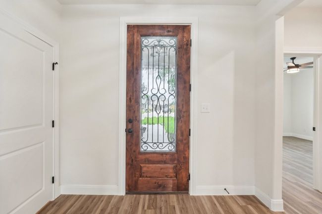 Entryway with baseboards, Vinyl Wood Plank floors, and ceiling fan | Image 9
