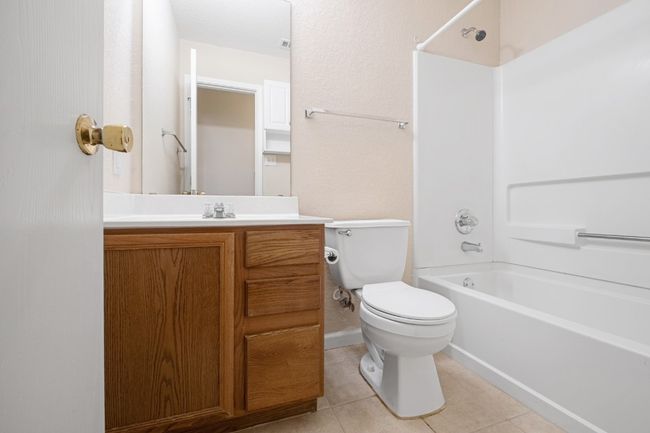 Full bath featuring vanity, shower / washtub combination, and tile patterned flooring | Image 20