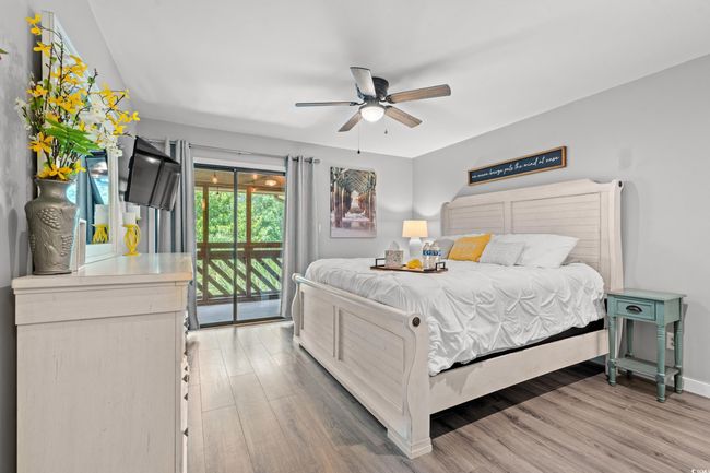 Bedroom featuring access to outside, light wood-type flooring, ceiling fan, and baseboards | Image 12