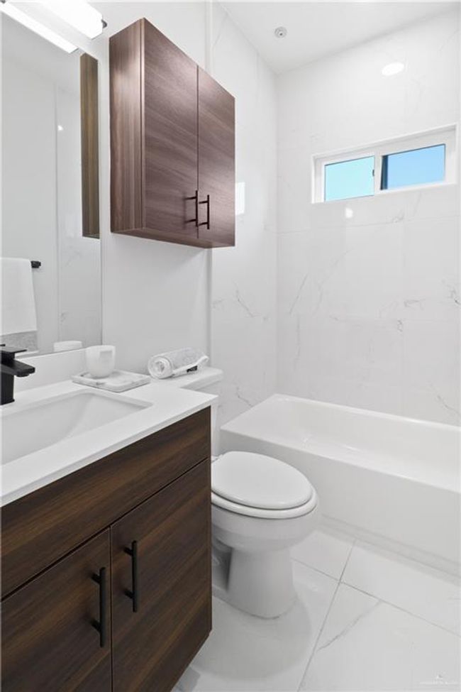 Full bathroom with vanity, tiled shower / bath, and toilet | Image 7