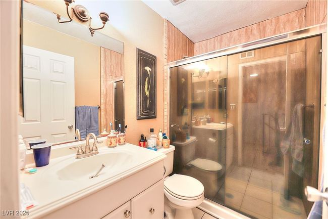 Bathroom with a shower stall, vanity, tiled flooring | Image 11