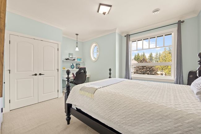 Bedroom featuring ornamental molding, light colored carpet, and a closet | Image 19