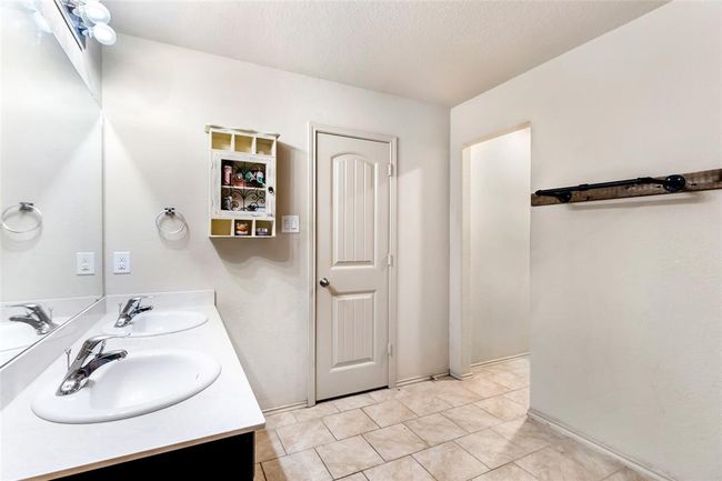 Another view of the primary bathroom, featuring dual sinks | Image 23