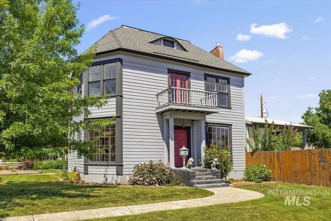 View of front of house featuring a balcony, a chimney, and roof with shingles | Image 6