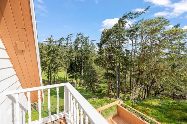 Balcony featuring view of wooded area | Image 25