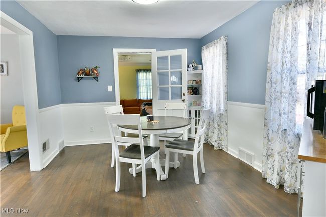 Dining space with visible vents and wood finished floors | Image 26