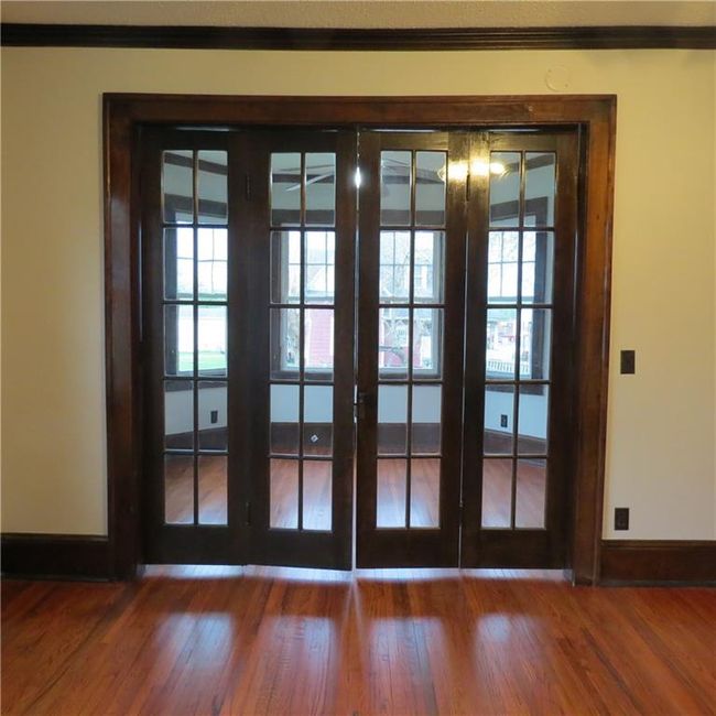 French folding doors open to a sun room - extension of living room | Image 7