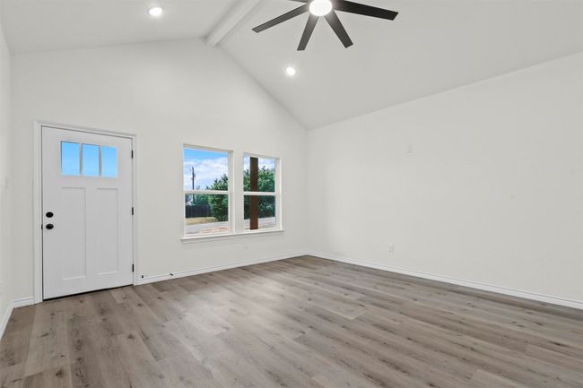 Entryway with light wood-type flooring, high vaulted ceiling, ceiling fan, and beam ceiling | Image 11