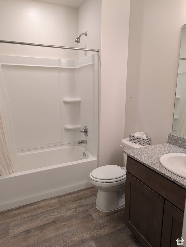 Bathroom with shower / tub combination, wood finished floors, toilet, and vanity | Image 22