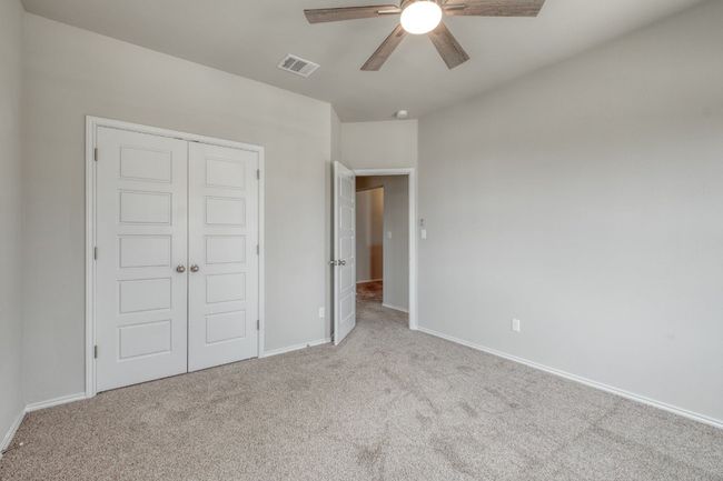 Unfurnished bedroom featuring carpet flooring, a closet, and a ceiling fan | Image 23