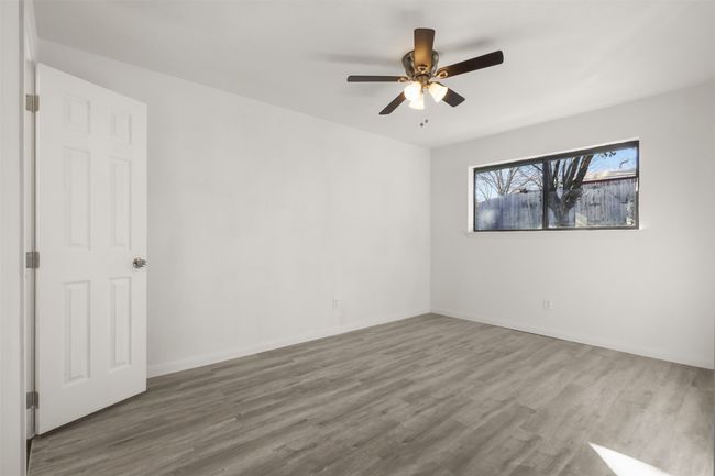 Unfurnished room featuring ceiling fan and wood-type flooring | Image 11
