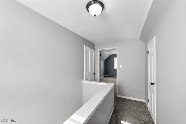 Carpeted hallway landing with two closets | Image 21