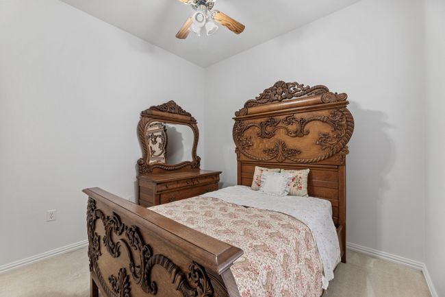 Carpeted bedroom featuring ceiling fan | Image 32