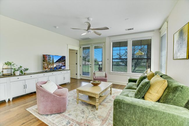 Living area featuring wood finished floors view to the lake. | Image 6