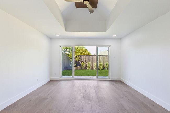 Another view of the large flex space with ceiling fan and extensive sliding doors. | Image 27