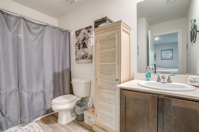 Full bath featuring vinyl floors, vanity, and shower | Image 28