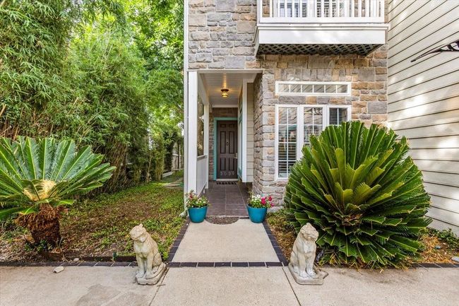 Built with exposed stone, this home is like an English Carriage House in a bayfront setting. | Image 4